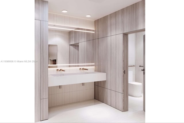 bathroom with tile patterned flooring, vanity, and tile walls