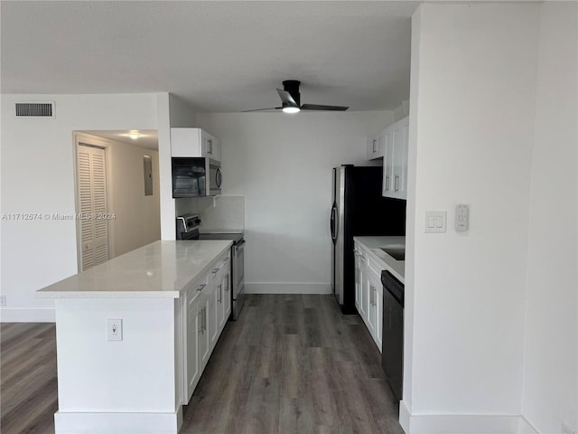 kitchen with kitchen peninsula, dark wood-type flooring, white cabinets, and stainless steel appliances