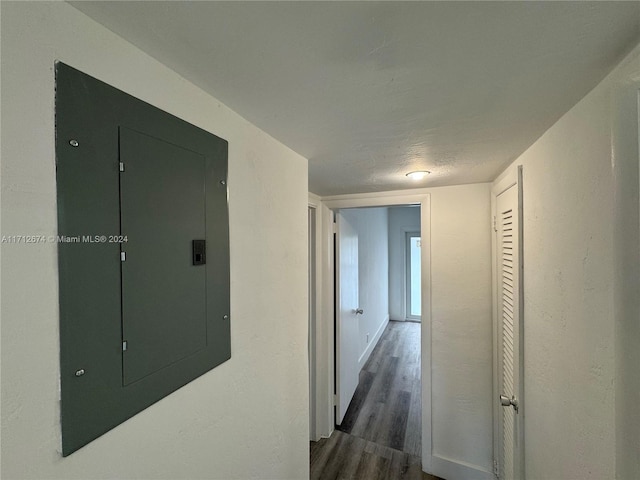 corridor with electric panel and dark hardwood / wood-style floors