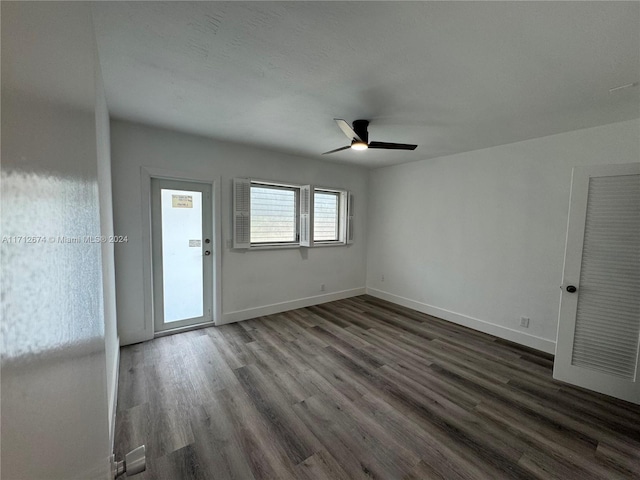 spare room featuring dark hardwood / wood-style flooring and ceiling fan