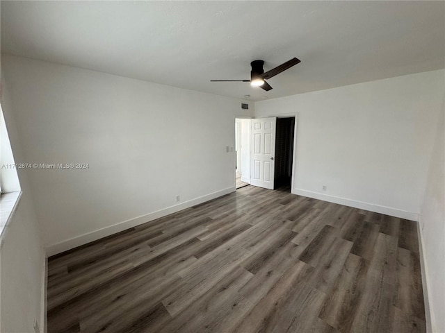 unfurnished bedroom featuring ceiling fan and dark hardwood / wood-style flooring