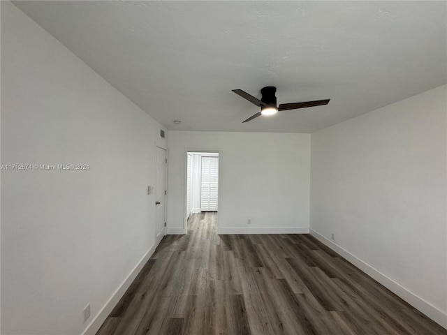 spare room with dark hardwood / wood-style floors and ceiling fan