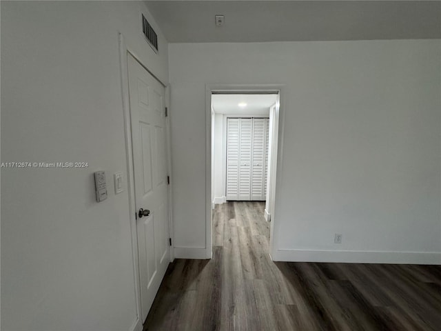 hall with wood-type flooring