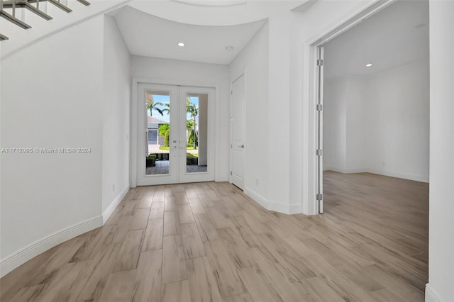 foyer featuring light wood-type flooring and french doors