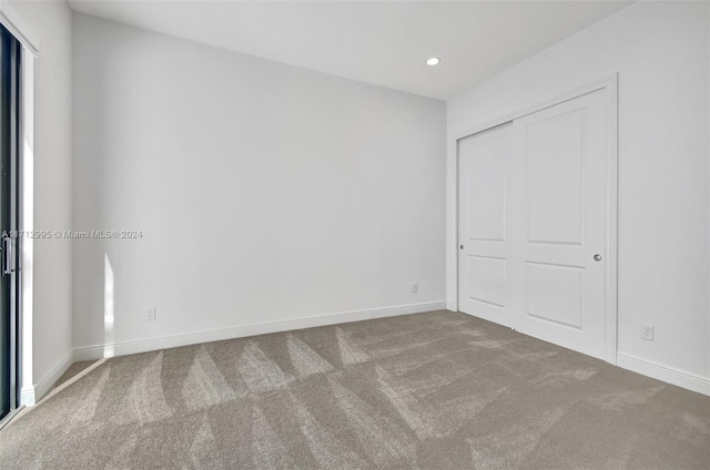 unfurnished bedroom with carpet and a closet