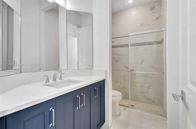 bathroom featuring vanity, a shower with shower door, and toilet