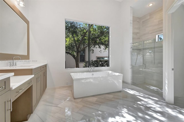 bathroom with vanity and independent shower and bath