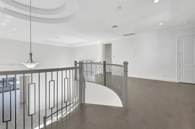 hallway with a tray ceiling and dark hardwood / wood-style flooring