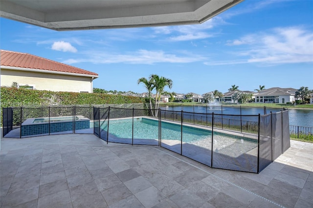 view of swimming pool featuring a patio area, a water view, and an in ground hot tub