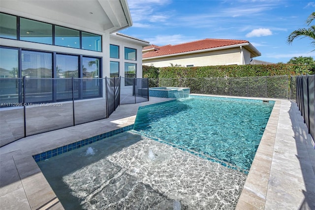 view of swimming pool with an in ground hot tub