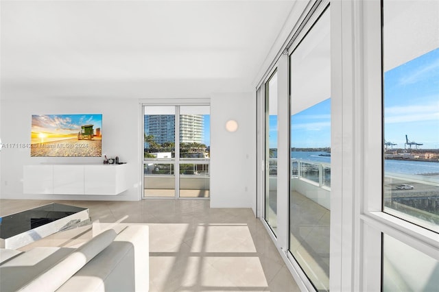 tiled living room with a water view