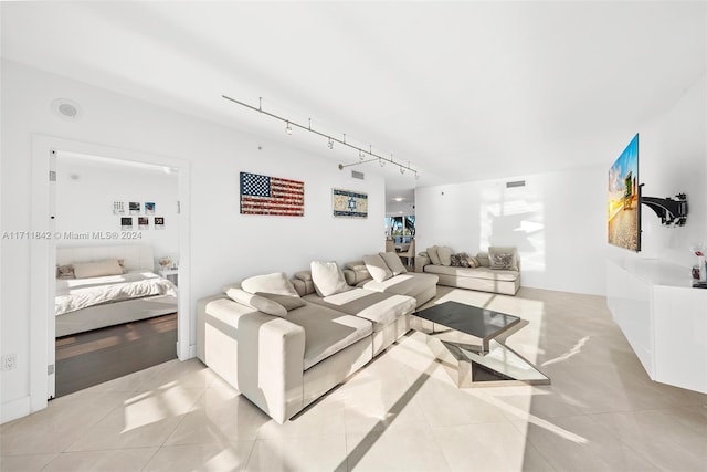 tiled living room featuring track lighting