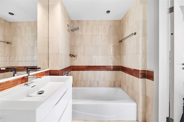 bathroom featuring vanity and tile walls