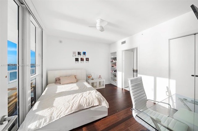 bedroom with dark hardwood / wood-style floors and ceiling fan