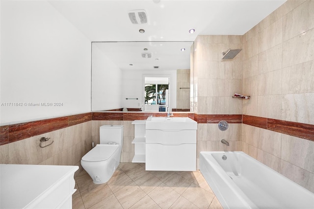 full bathroom with tile patterned floors, vanity, toilet, and tile walls