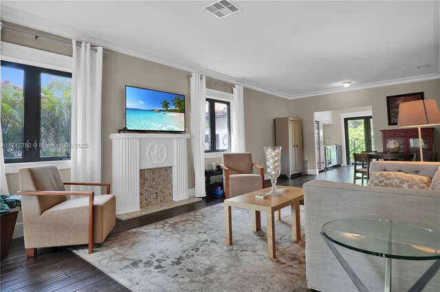 living room featuring dark hardwood / wood-style flooring and crown molding