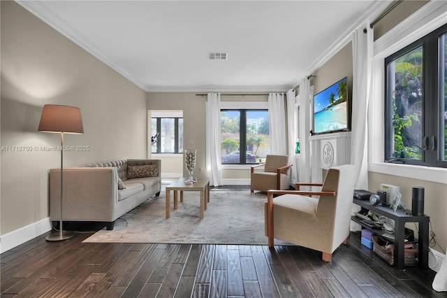 living room featuring dark hardwood / wood-style flooring and ornamental molding