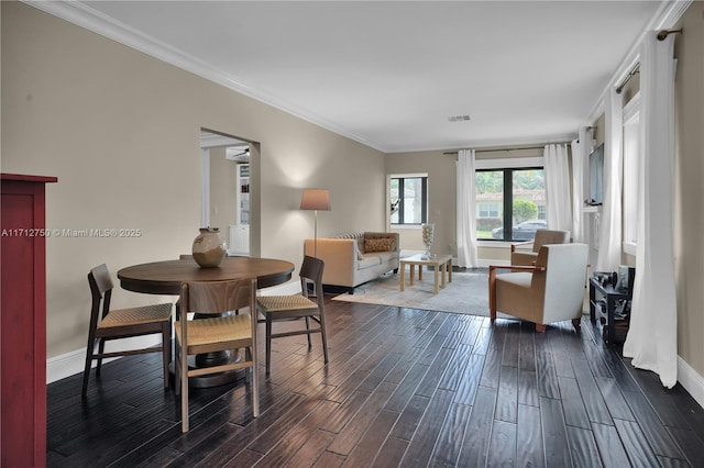 dining space featuring ornamental molding and dark wood-type flooring