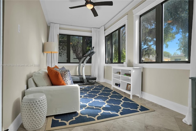 sitting room featuring ceiling fan and a wealth of natural light