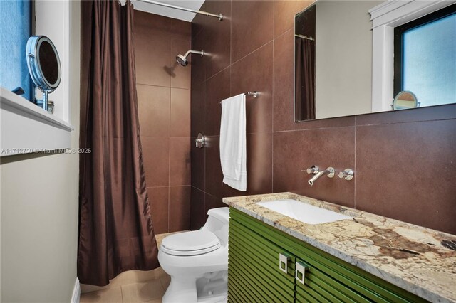 bathroom featuring curtained shower, tile walls, decorative backsplash, vanity, and toilet