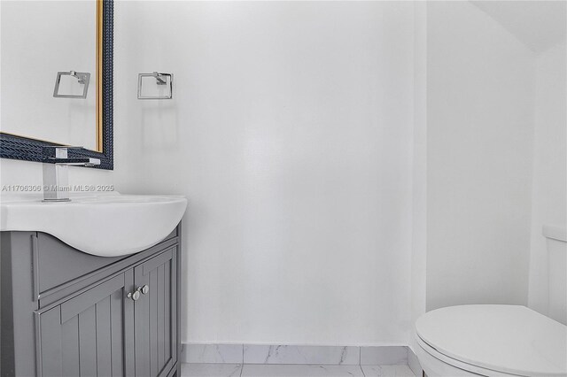 bathroom with vanity, toilet, and vaulted ceiling