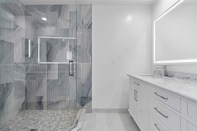 bathroom featuring vanity and a shower with shower door