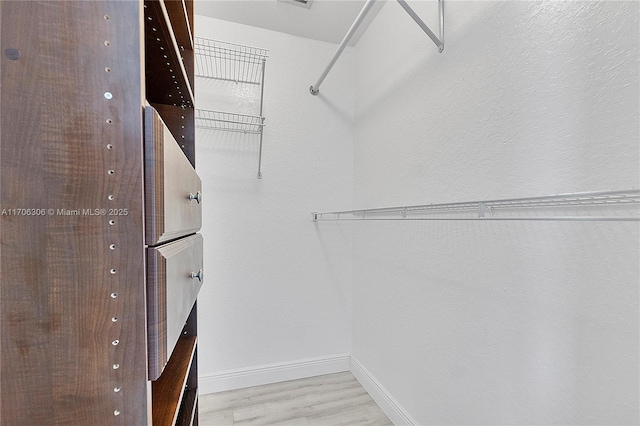 walk in closet featuring light wood-type flooring