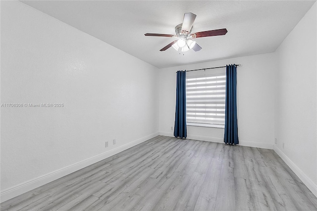 empty room featuring light wood-type flooring and ceiling fan