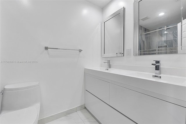 bathroom with tile patterned flooring, vanity, toilet, and a shower with shower door