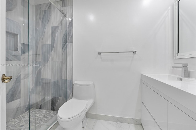 bathroom featuring vanity, toilet, and a shower with shower door