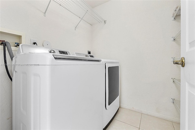 laundry area featuring independent washer and dryer and light tile patterned floors