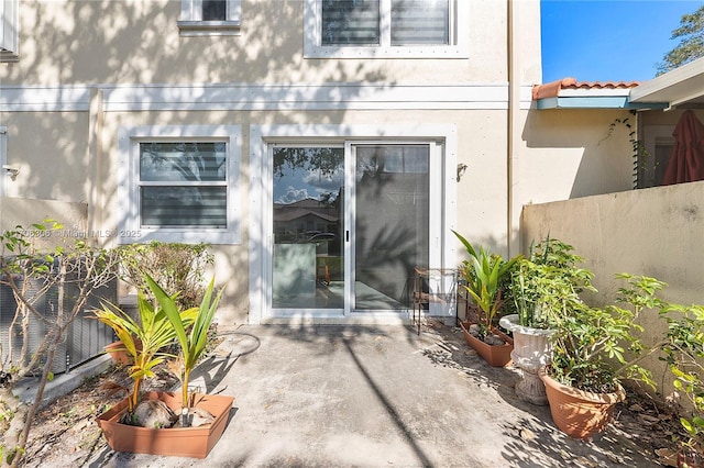 view of exterior entry featuring a patio