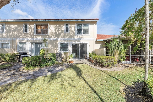 rear view of property with a lawn