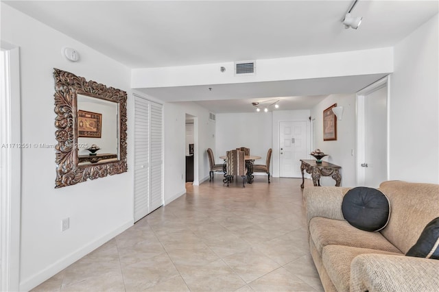 tiled living room with rail lighting