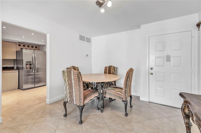 dining space featuring visible vents and light tile patterned flooring