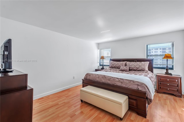 bedroom featuring baseboards and light wood-style floors