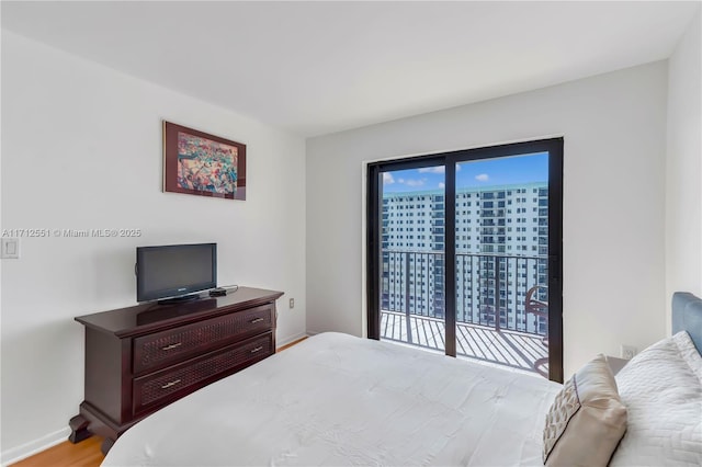 bedroom with baseboards and wood finished floors