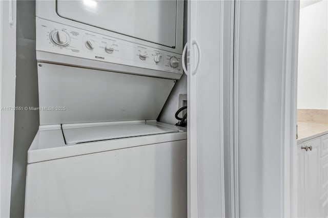 washroom with laundry area and stacked washer / drying machine