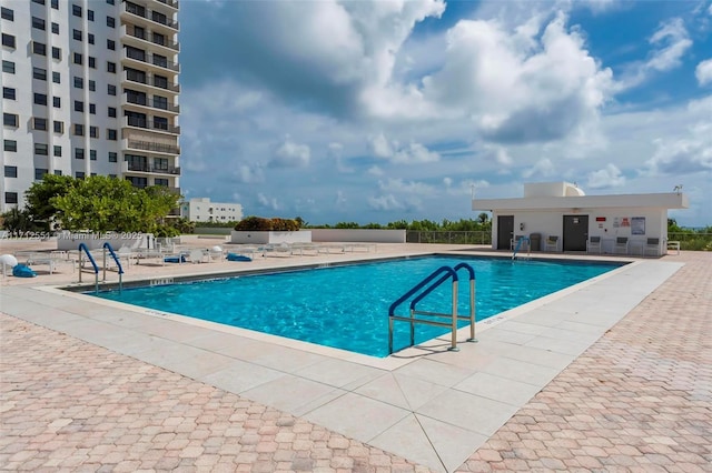 pool featuring a patio area and fence