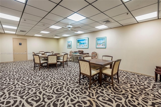 dining area featuring carpet, visible vents, and a drop ceiling