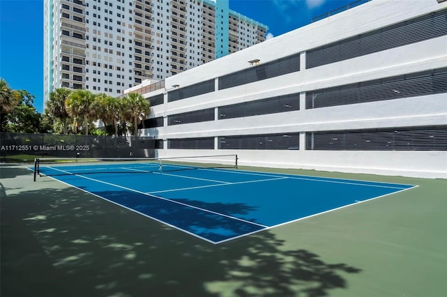 view of tennis court with fence