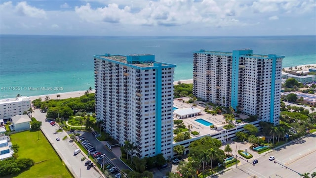 drone / aerial view with a city view and a water view