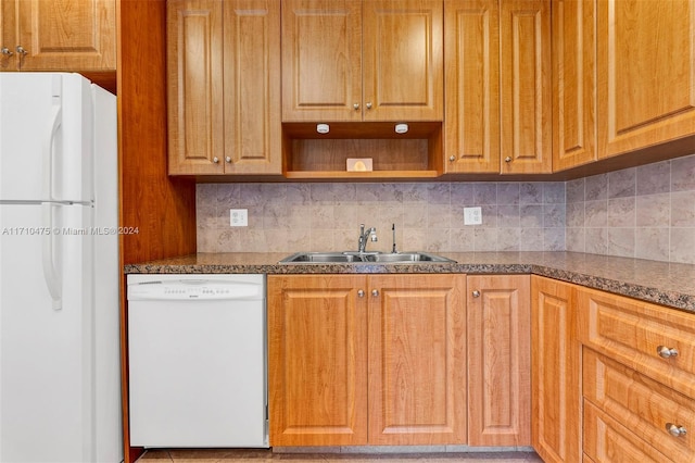 kitchen with backsplash, sink, and white appliances