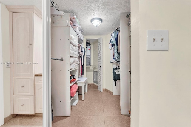 spacious closet with light tile patterned floors