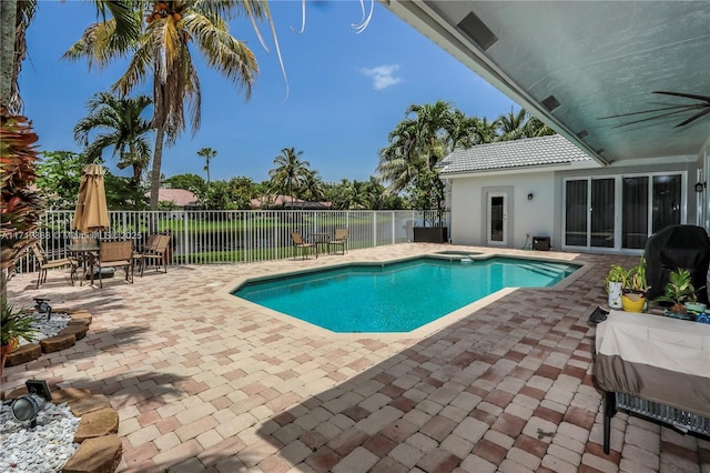 view of swimming pool featuring a patio, area for grilling, and ceiling fan