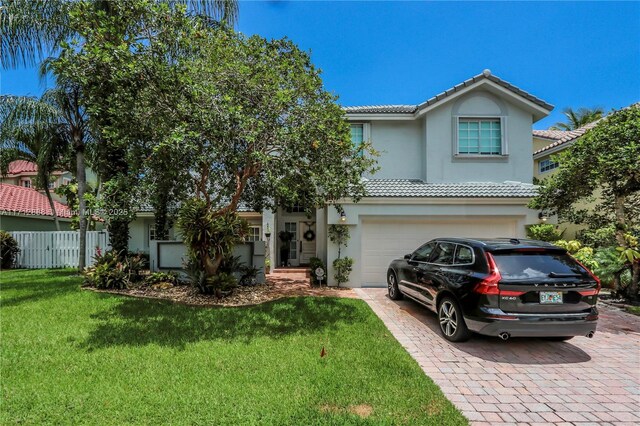 view of front of property featuring a garage and a front yard