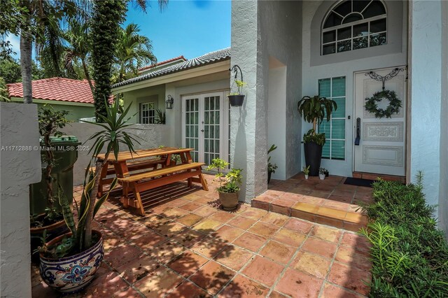 entrance to property featuring a patio area and french doors