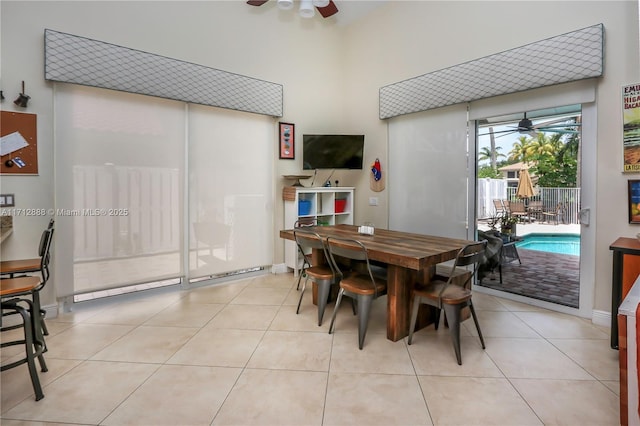 tiled dining area with ceiling fan