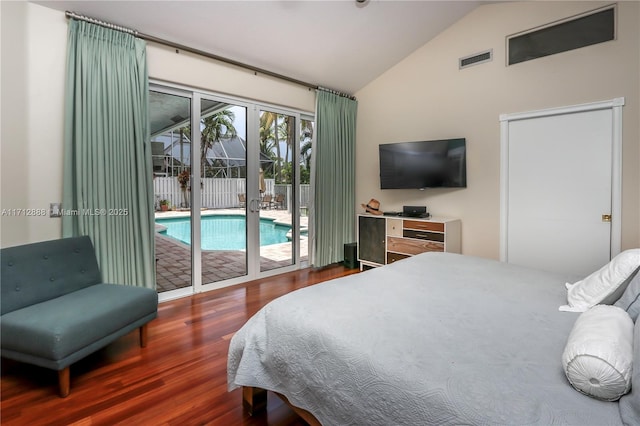 bedroom with dark wood-type flooring, vaulted ceiling, and access to outside