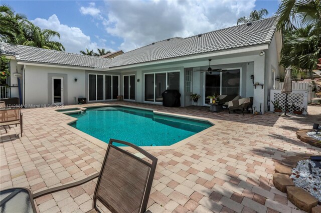 view of pool with a patio and ceiling fan